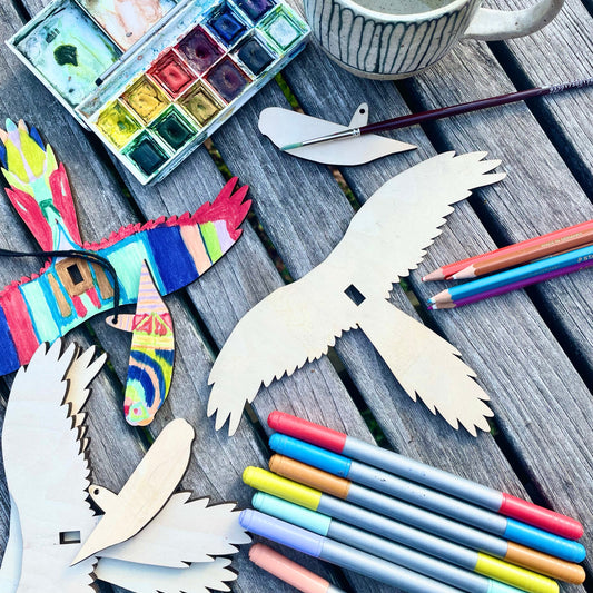 wooden birds with crayons, pencils and paints