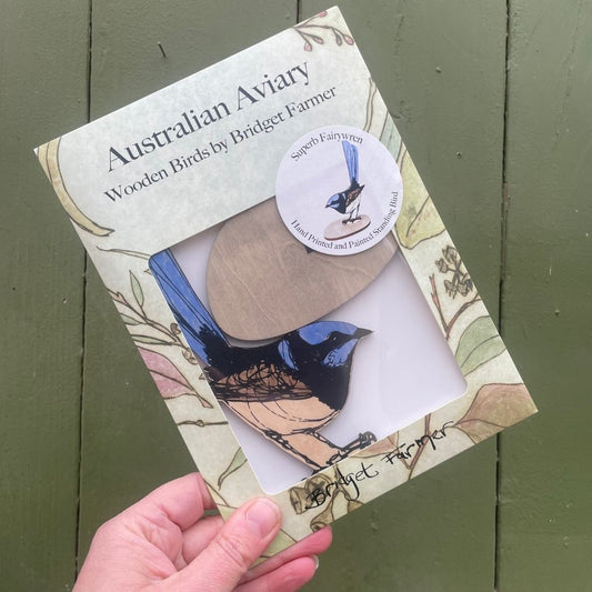 Packaged wooden bird figurine with 'Australian Aviary' branding on a green background