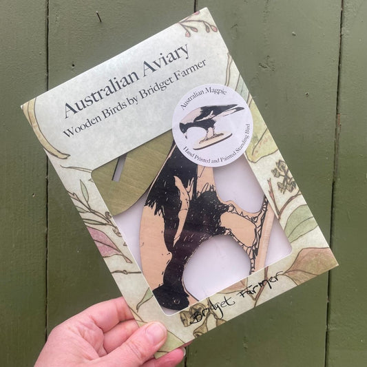 Packaged wooden birds by Bridget Farmer with 'Australian Aviary' branding on a green background